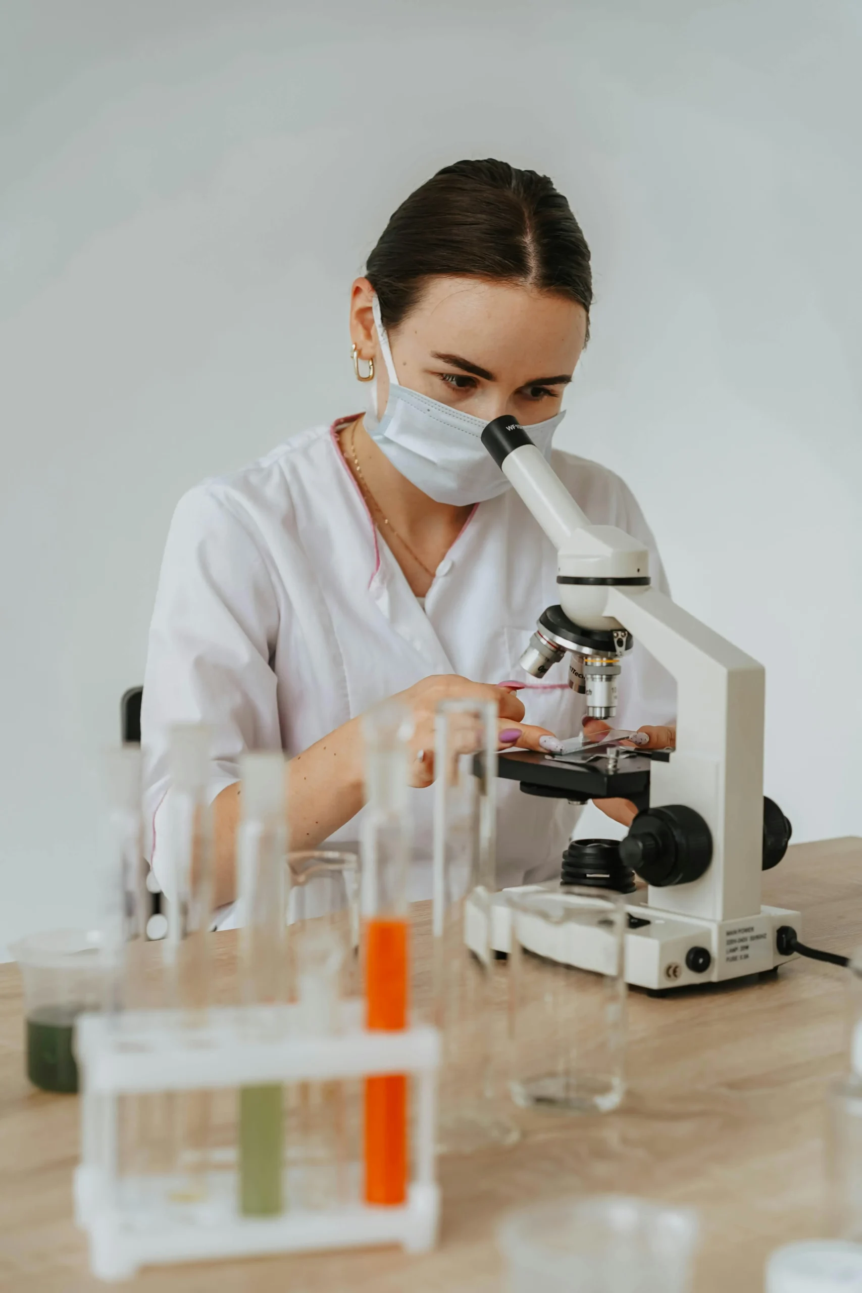 Laboratory technician analyzing blood sample using advanced microscope equipment